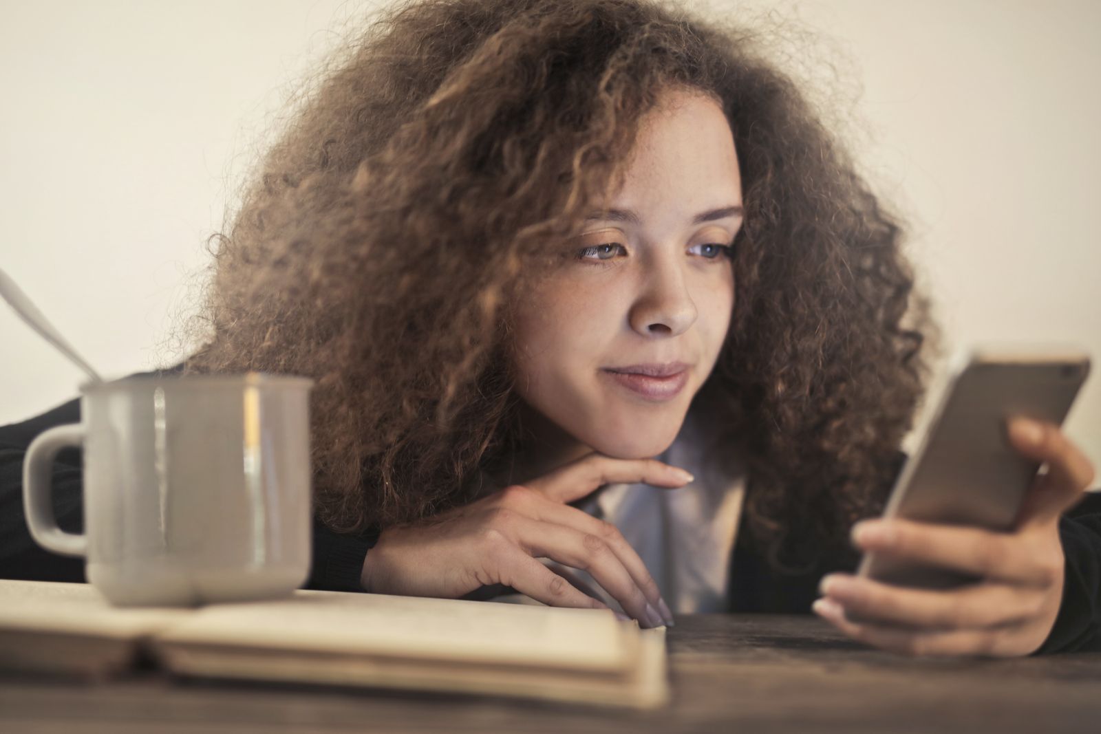 A person checking a savings account balance on a phone at home