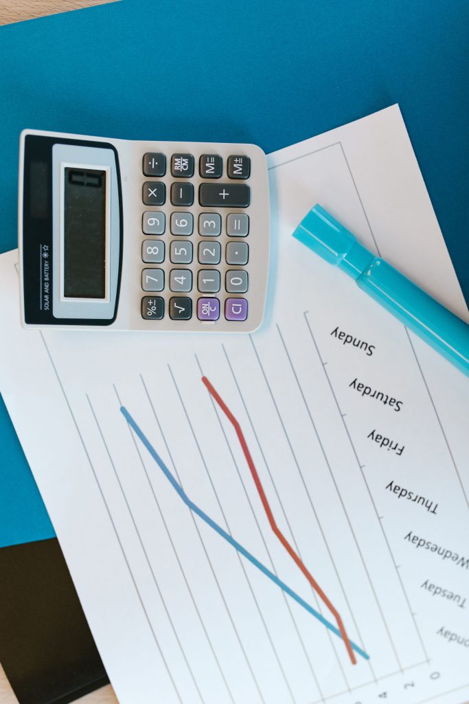 A calculator on graph paper with rising and falling lines