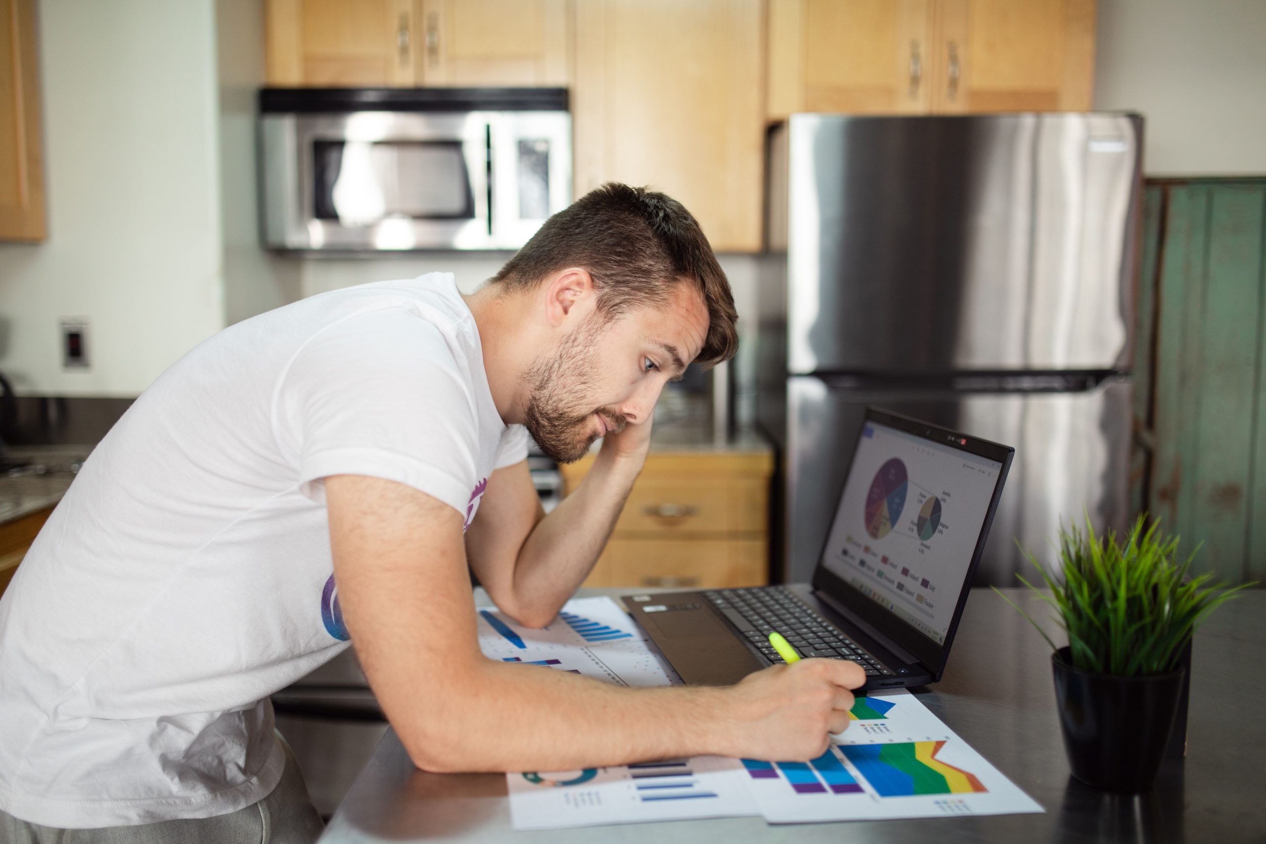 A person reviewing a long term savings plan on a laptop at home