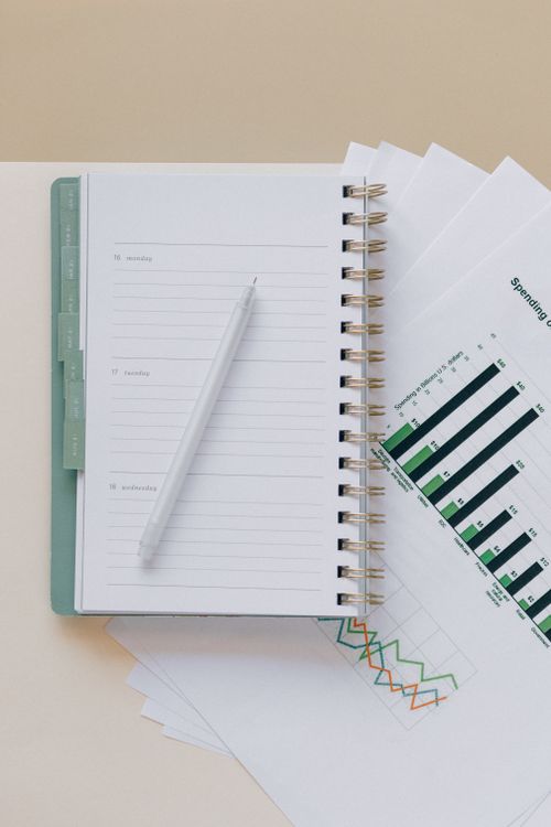 Open weekly planner with a pen on graph paper